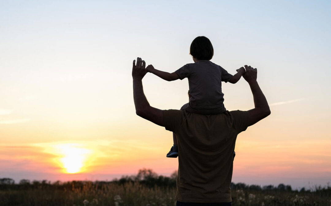 A child on their father's shoulders